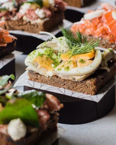 Scandinavian snack. Smorrebrod. Traditional Danish sanwiches, dark rye bread with different topping