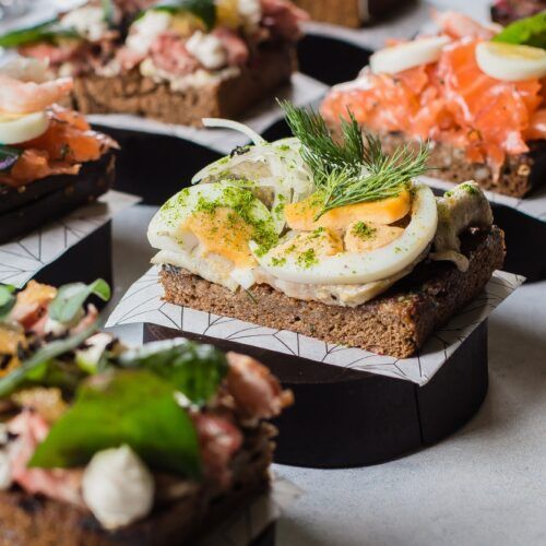 Scandinavian snack. Smorrebrod. Traditional Danish sanwiches, dark rye bread with different topping